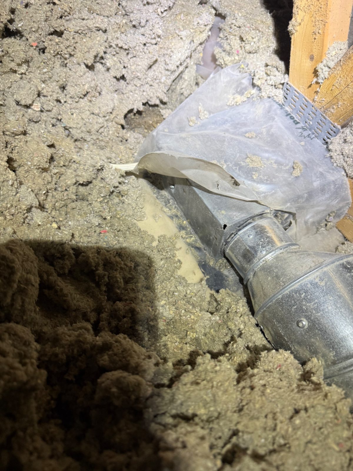 A torn vapour barrier flapping over exposed ductwork &mdash; small problems worth fixing while the attic is open.