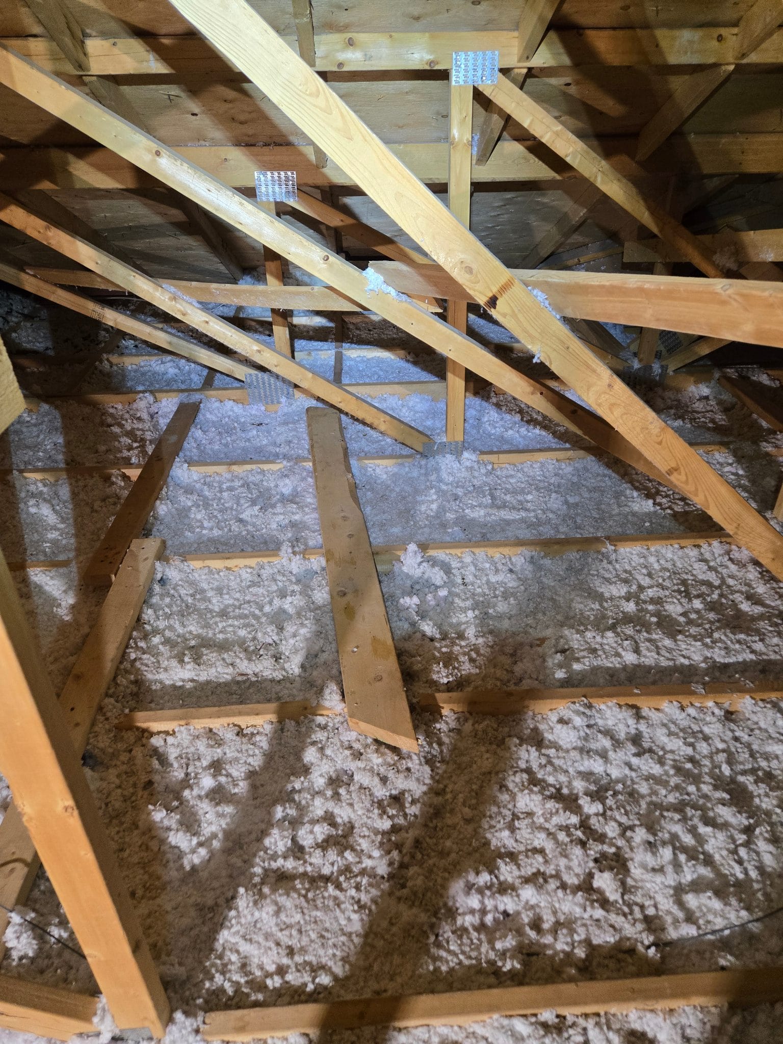 Joists standing fully proud of the insulation &mdash; each one a thermal bridge.