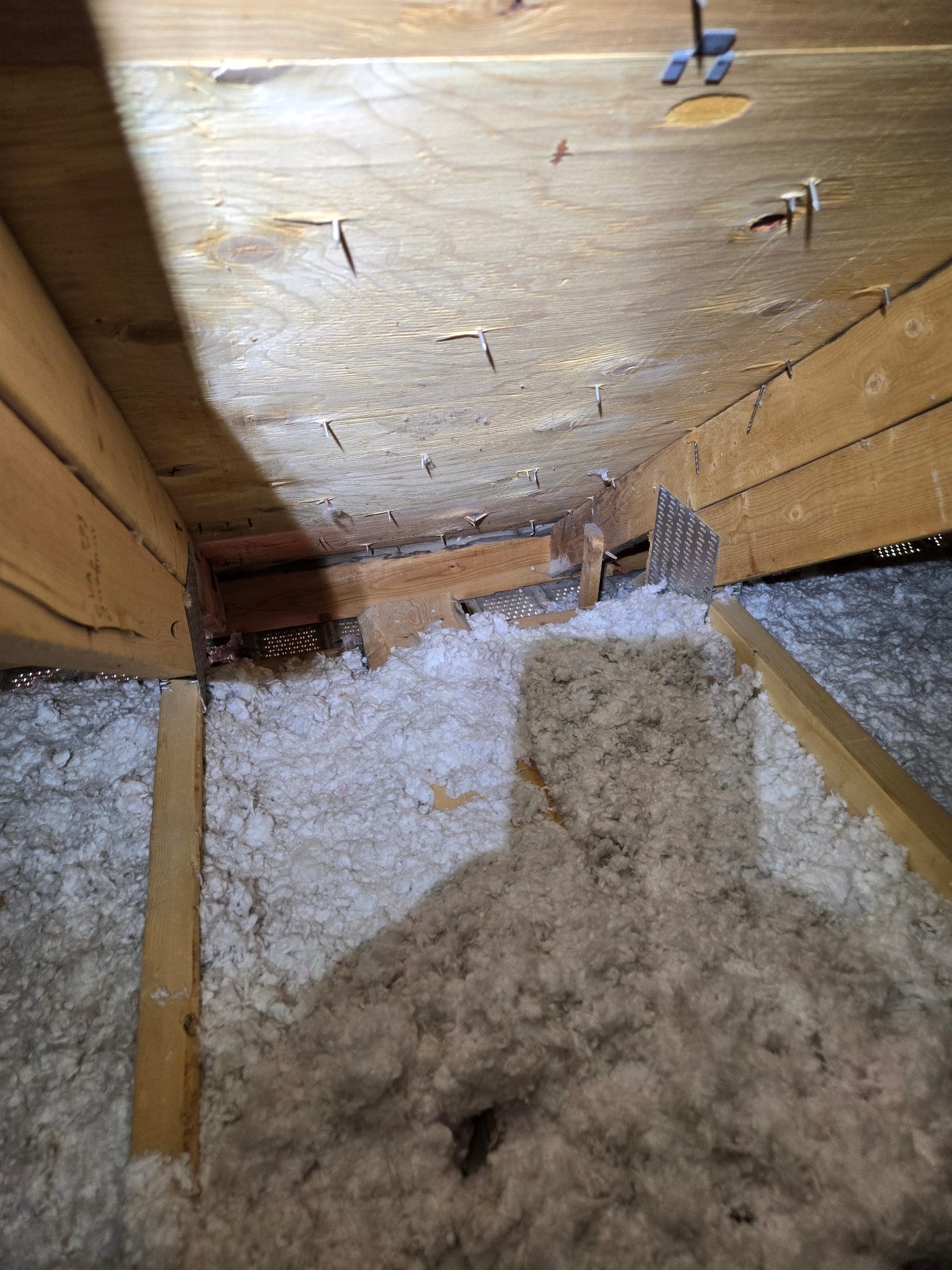 The eave bays &mdash; baffled before blowing so the new insulation never chokes the airflow.