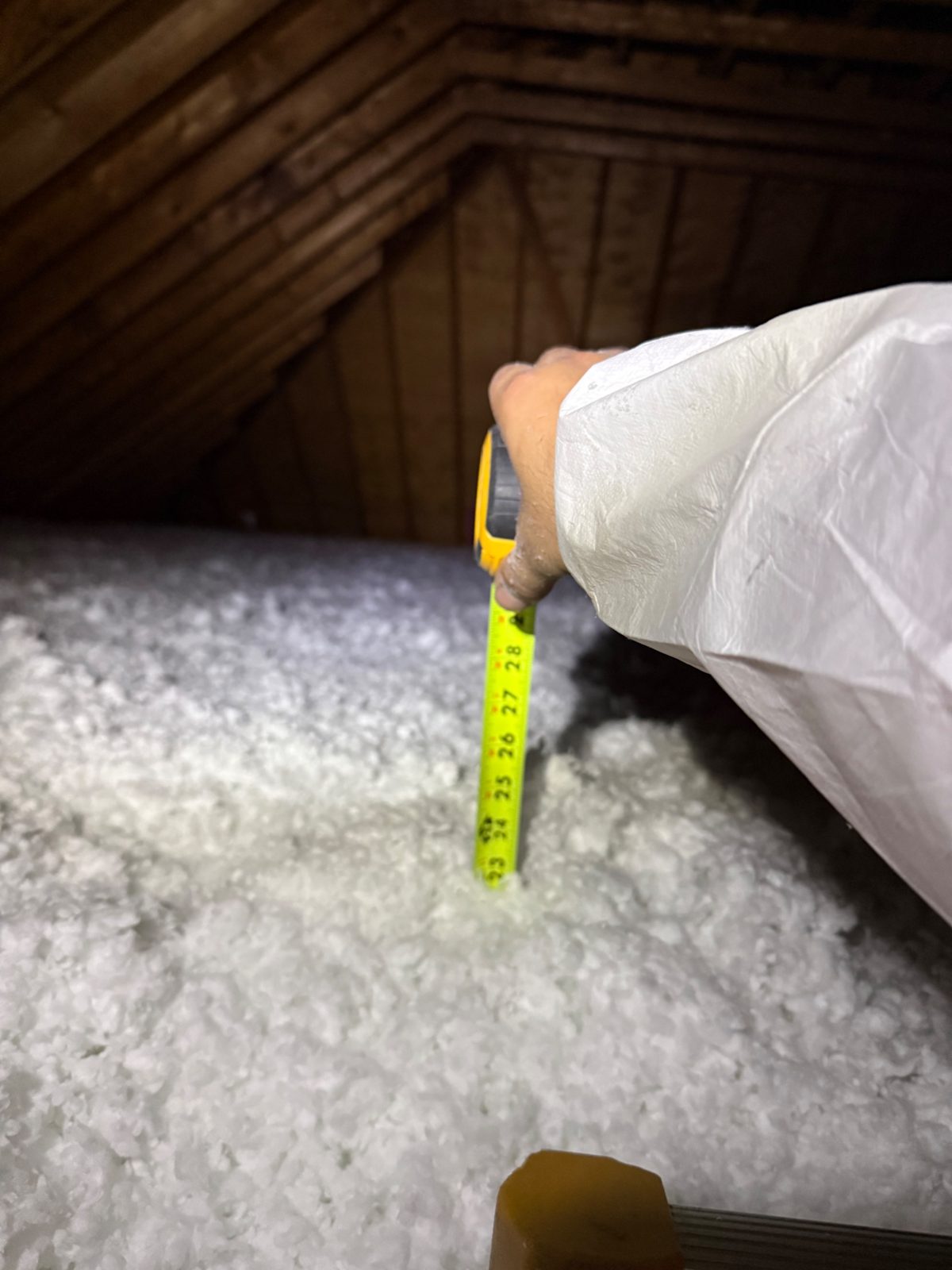 Step 3 &mdash; the ruler buried at 22&Prime;+ of brand-new insulation: R-60.