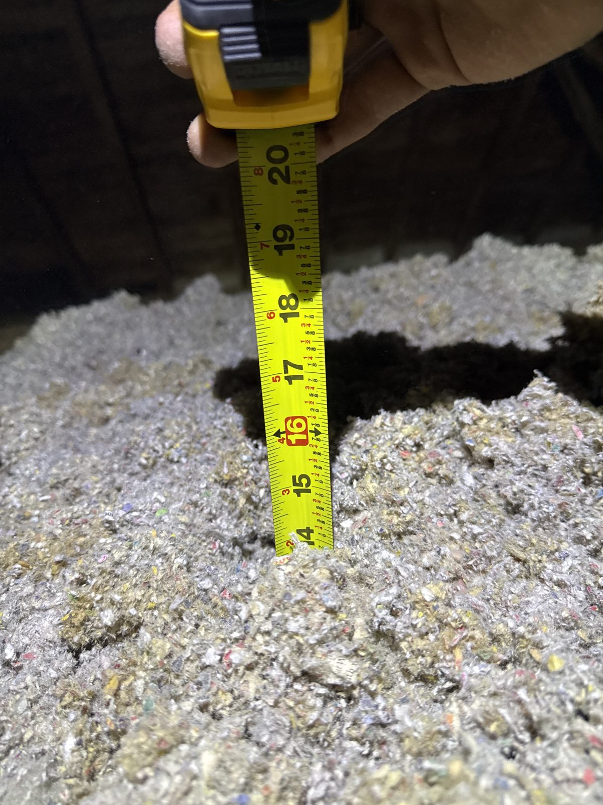 The tape tells the story: only a few inches of settled insulation where today’s standard calls for 21.5″.