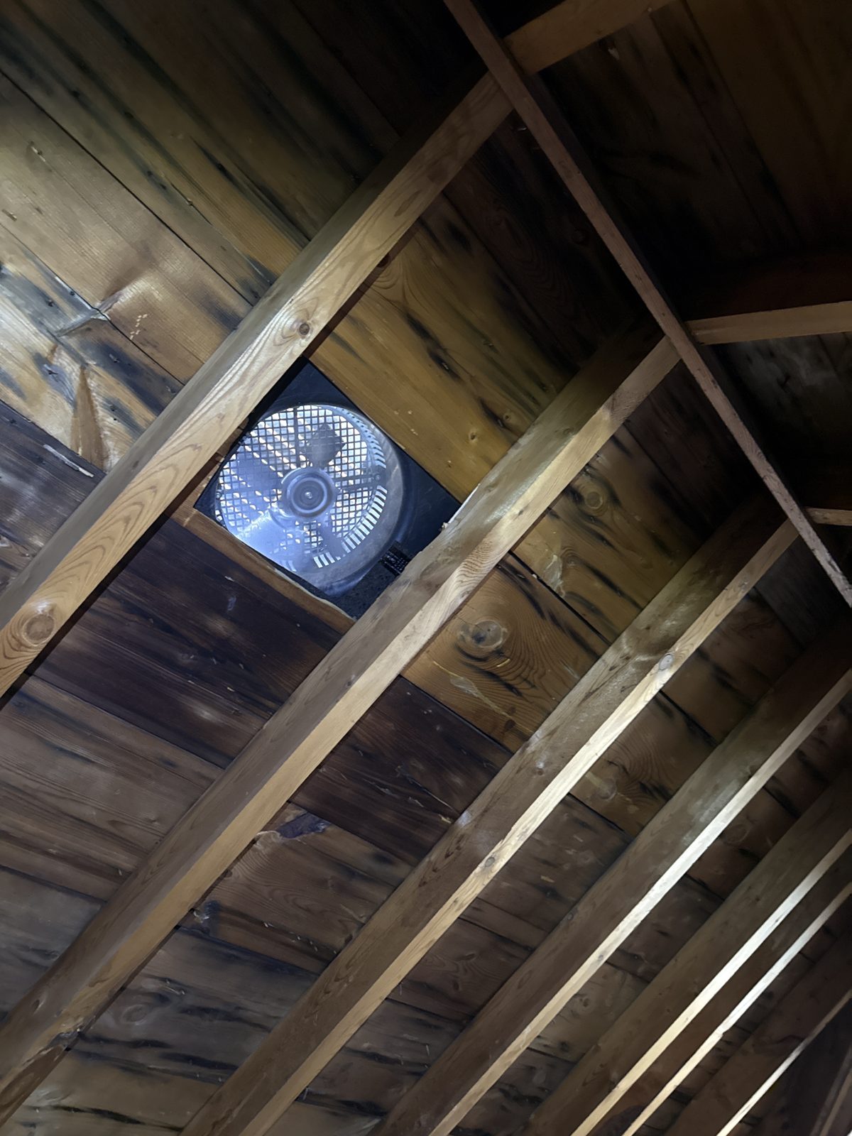 A powered fan on a roof that was still staining — hardware can’t fix a system problem.