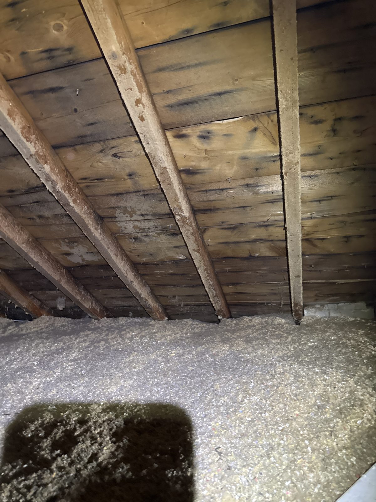 Completely uninsulated knee-wall boards — a straight thermal highway out of the house.