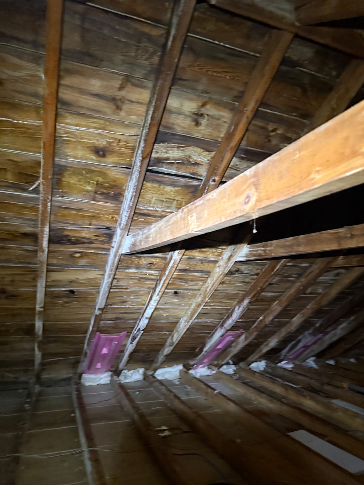 Step 2 — the intake path rebuilt: new baffle vents at every eave bay, foam-sealed along the soffit line, against remediated sheathing.