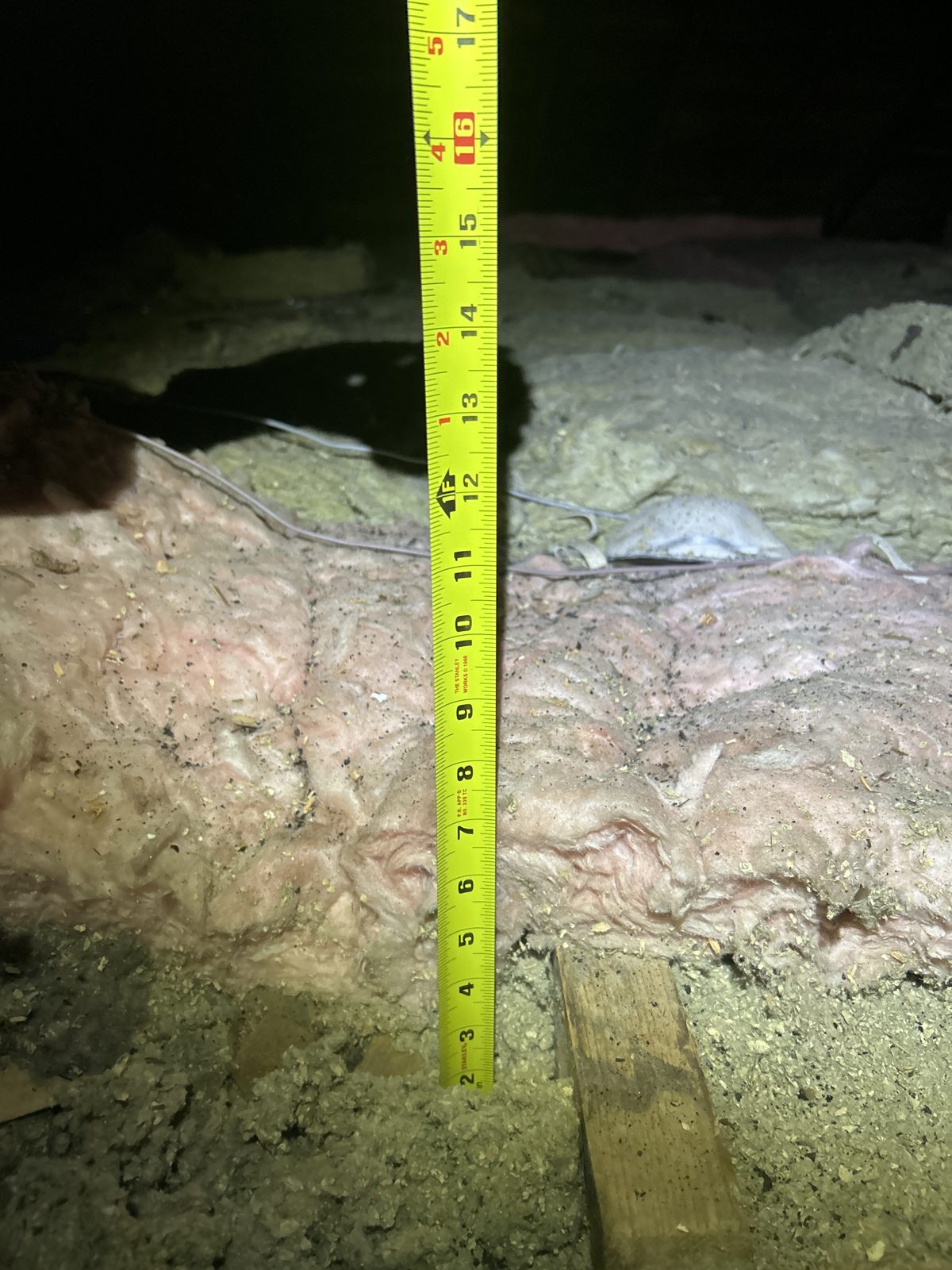 Shallow, uneven coverage: a patchwork of old fiberglass and cellulose.