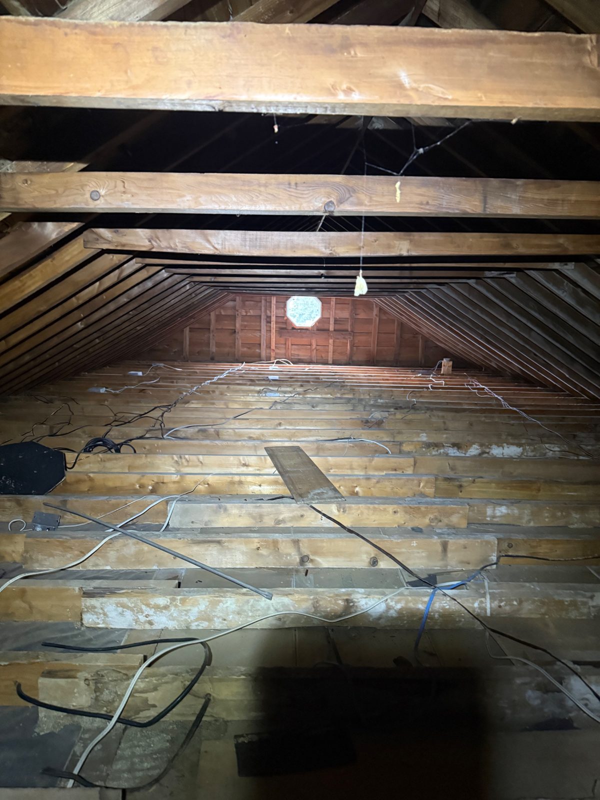 Step 1 — stripped to bare joists: all 1,008 sq ft of old insulation and debris removed, right to the boards.