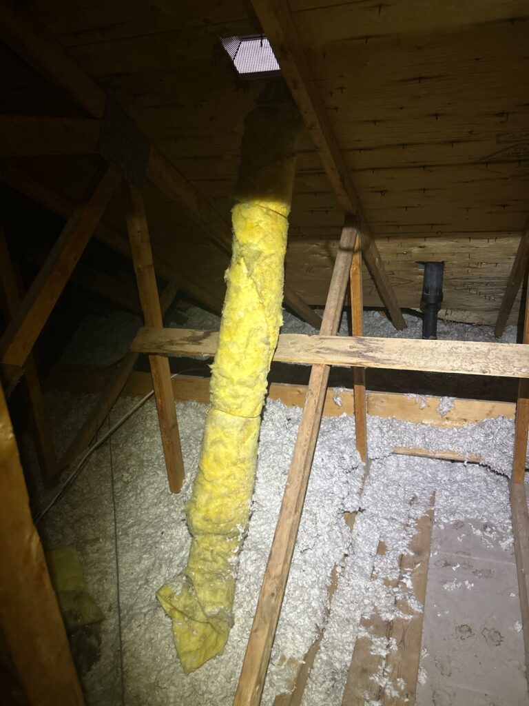An exhaust duct meandering through the attic — moisture had been escaping into the cold space instead of outside.