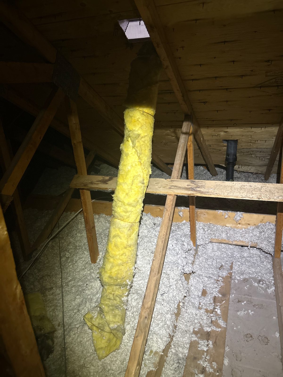 An exhaust duct meandering through the attic — moisture had been escaping into the cold space instead of outside.