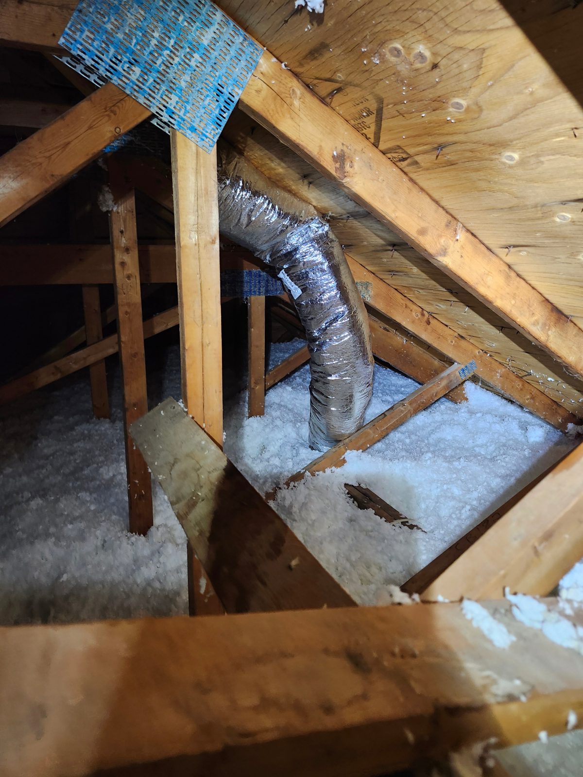 Done right: an insulated appliance duct routed to its own dedicated, damped roof cap in Woodbridge.