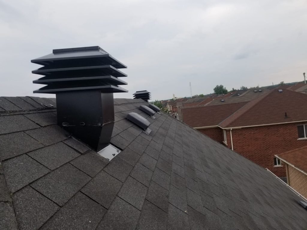 Tower vents near the ridge — higher-capacity static exhaust for large or complex attics.